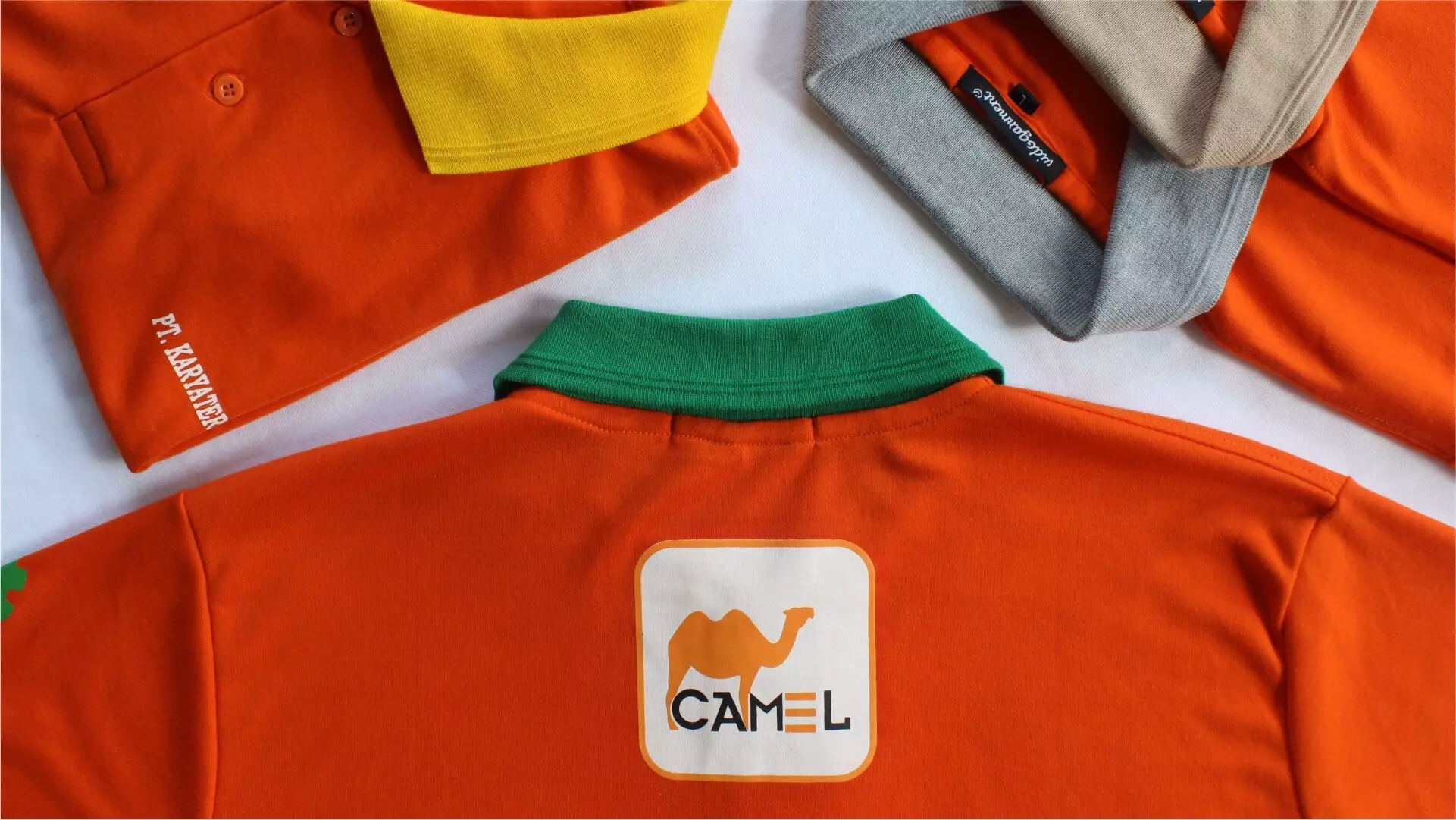 Deretan kaos polo oranye pesanan seragam terlipat rapi